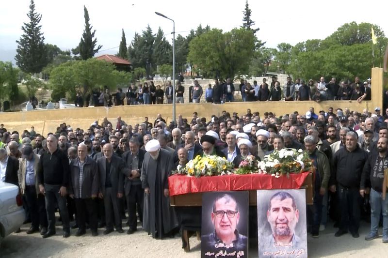 In this grab taken from video, mourners pray over the coffin of Lebanese money changer Mohammad Srour, 57, who was found tortured and killed inside a villa in Monte Verdi neighborhood of Beit Meri, during his funeral procession in Labweh village, near the border with Syria, northeast Lebanon, Thursday, April 11, 2024. The mysterious abduction and murder of a United States-sanctioned Lebanese money changer in a three-story villa on the edge of a quiet mountain resort town overlooking Beirut was most likely the work of Israeli operatives, Lebanon's interior minister said Wednesday. (AP Photo)