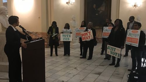 Kathryn Rice speaks in favor of creating the city of Greenhaven as supporters hold signs during a press conference at the State Capitol on Feb. 15, 2018.
