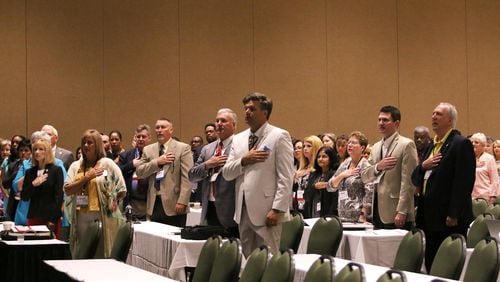 Georgia tax officials say the pledge of allegiance during the Georgia Association of Tax Officials Conference on May 6, 2019, at the Classic Center in Athens. CHRISTINA R. MATACOTTA / CHRISTINA.MATACOTTA@AJC.COM