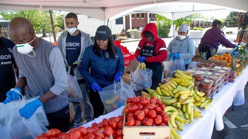 Volunteers assemble food bags before the start of the City of College Park Recreation and Cultural Arts Department's first pop-up grocery store in College Park Saturday, April 18, 2020. STEVE SCHAEFER / SPECIAL TO THE AJC