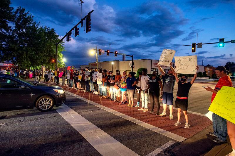Protesters and police square off in 2020 protests of the George Floyd killing in downtown Gainesville. The event threatened to turn violent, until the Rev. Rose Johnson called for prayer and launched several public conversations.
(Courtesy of Jennie Clayton Photography)