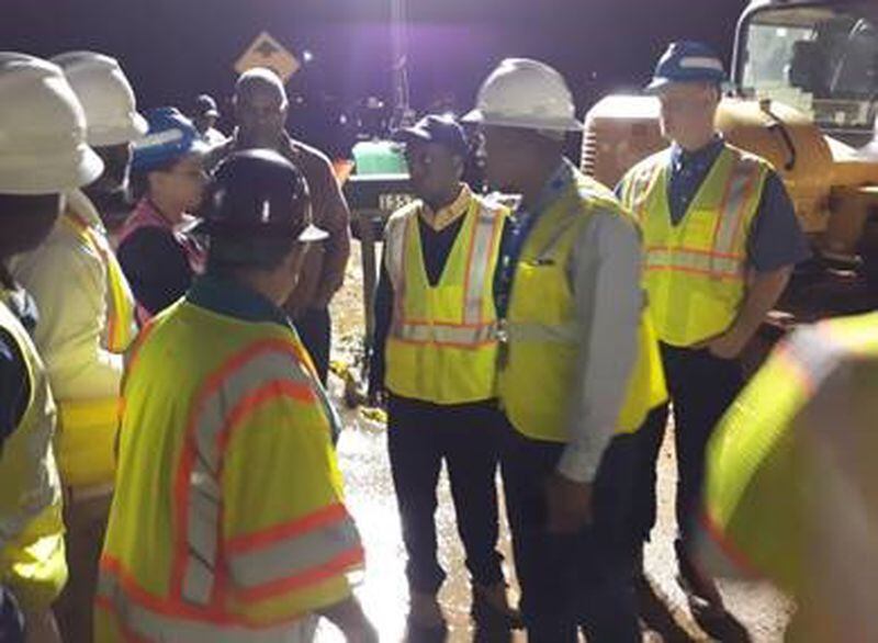 DeKalb County CEO Michael Thurmond talks with crews at the site of the Peachcrest Road water main.
