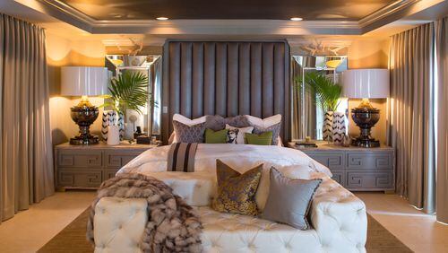 Using an elephant grey and cream palette, Atlanta-based Reiner White Design Studio created a sophisticated and restful master suite in this Miami home. The lavish headboard, nightstands and tufted sofa are custom pieces (from ModShop). Contributed by Robin Hill