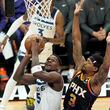 Minnesota Timberwolves guard Anthony Edwards (5) tries to get off a shot as Phoenix Suns guard Bradley Beal (3) defends during the first half of Game 4 of an NBA basketball first-round playoff series, Sunday, April 28, 2024, in Phoenix. (AP Photo/Ross D. Franklin)