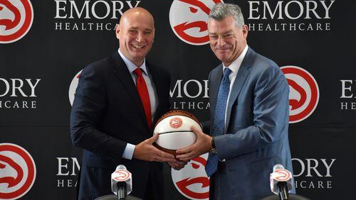 New Hawks GM Travis Schlenk (left) and Hawks principal owner Tony Ressler hold a basketball during an introductory press conference on Friday, June 2, 2017. HYOSUB SHIN / HSHIN@AJC.COM