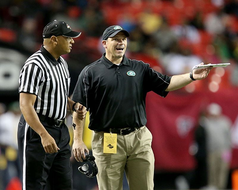 December 14, 2013 - Atlanta, Ga.: Griffin coach Steven DeVoursney, center, argues a call with an official in the first half of their game against Carrollton in the Class AAAA championship game at the Georgia Dome Saturday night in Atlanta, Ga., December 14, 2013. JASON GETZ / JGETZ@AJC.COM Steven DeVoursney was 128-35 in 13 seasons at Griffin. (Jason Getz / AJC File)