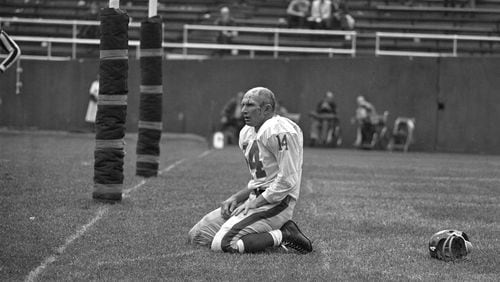 Giants quarterback Y.A. Tittle, in the final season of his career, was photographed helmet-less, bloodied and kneeling immediately after having been knocked to the ground by John Baker of the Pittsburgh Steelers and throwing an interception that was returned for a touchdown at the old Pitt Stadium in 1964.