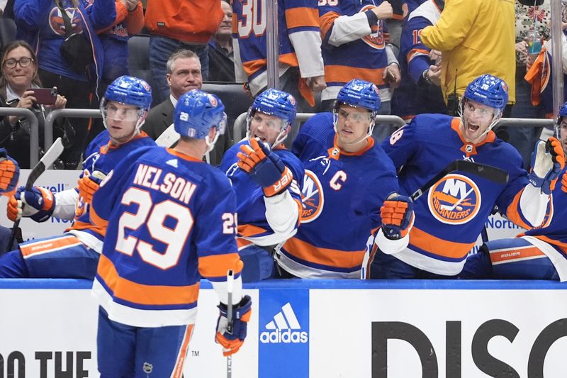 New York Islanders' Brock Nelson is congratulated for a goal against the Carolina Hurricanes during the second period of Game 3 of an NHL hockey Stanley Cup first-round playoff series Thursday, April 25, 2024, in Elmont, N.Y. (AP Photo/Frank Franklin II)