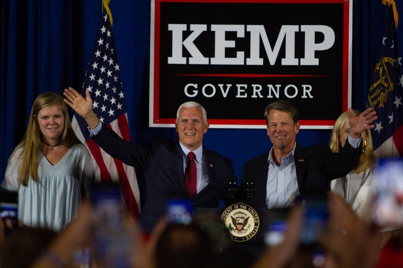 Vice President Mike Pence and  Secretary of State Brian Kemp talk at a rally in Macon GA Saturday, July 21, 2018. Vice President Mike Pence endorsed Brian Kemp for Governor during the event. STEVE SCHAEFER / SPECIAL TO THE AJC