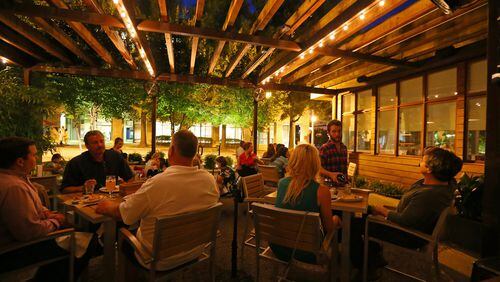 Patrons enjoy late-night dining on the patio at Leon’s Full Service in Decatur, one of our dining team’s favorite hideaways. CURTIS COMPTON / CCOMPTON@AJC.COM