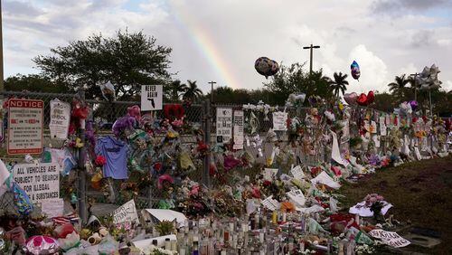 A rainbow is seen over the memorial outside of Marjory Stoneman Douglas High School in Parkland Fla., Monday, Feb. 26, 2018. (Joe Cavaretta /South Florida Sun-Sentinel via AP)