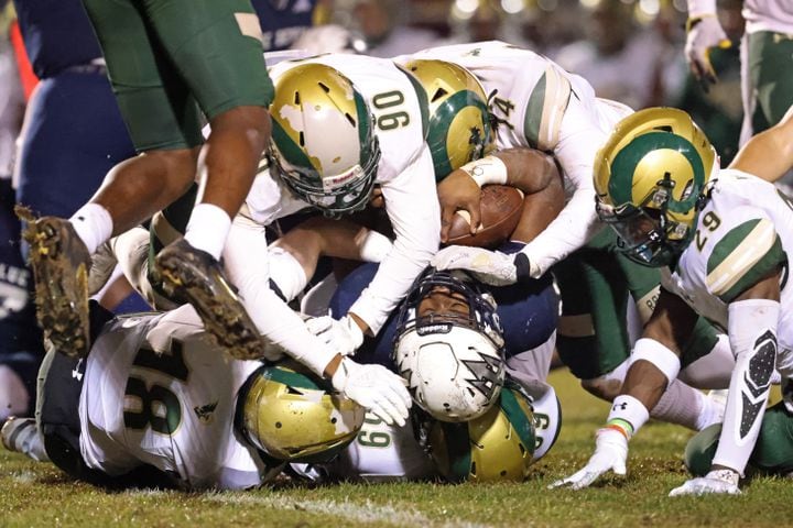 Dec. 18, 2020 - Norcross, Ga: Norcross running back Jahni Clarke (28) is bent backwards by a host of Grayson defenders after a run by Clarke in the first half of the Class AAAAAAA semi-final game at Norcross high school Friday, December 18, 2020 in Suwanee, Ga.. JASON GETZ FOR THE ATLANTA JOURNAL-CONSTITUTION