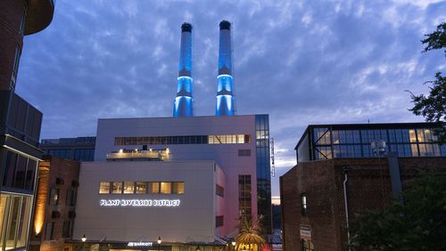 Illuminated 176-foot twin smokestacks light up the newly opened Plant Riverside District entertainment district in Savannah. 
Courtesy of Plant Riverside District