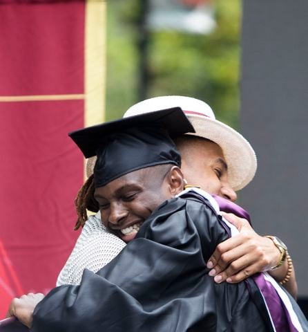 A Morehouse College graduate hugs a friend after exiting the stage during the Morehouse College commencement ceremony on Sunday, May 21, 2023, on Century Campus in Atlanta. The graduation marked Morehouse College's 139th commencement program. CHRISTINA MATACOTTA FOR THE ATLANTA JOURNAL-CONSTITUTION