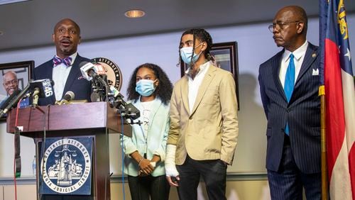 Attorney Mawuli Mel Davis (left) speaks on behalf of Taniyah Pilgrim (second from left) and Messiah Young (second from right)during a press conference by the Fulton County District Attorney's Office in Atlanta, Monday, June 2, 2020. District Attorney Paul Howard and members of the Fulton County District Attorney's Office are pressing charges against 6 Atlanta Police Officers for their involvement in the assault and property damage to Taniyah Pilgrim and Messiah Young.  Attorney Mawuli Mel Davis is representing Messiah Young. (ALYSSA POINTER / ALYSSA.POINTER@AJC.COM)