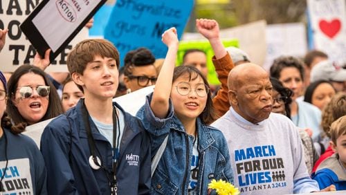 Ethan Asher, left, and Kailen Kim march with Congressman John Lewis at the March For Our Lives event in downtown Atlanta on March 24, 2018. ( Steve Eberhardt / Courtesy of March for Our Lives)