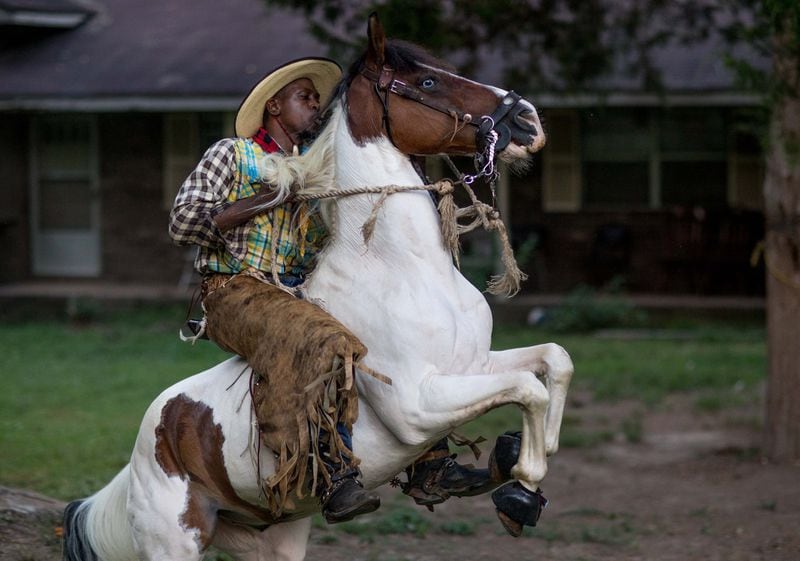 Arkansas Dave, who competes in rodeos, rides his horse on a ranch off Flat Shoals Road in Union City. BRANDEN CAMP / SPECIAL