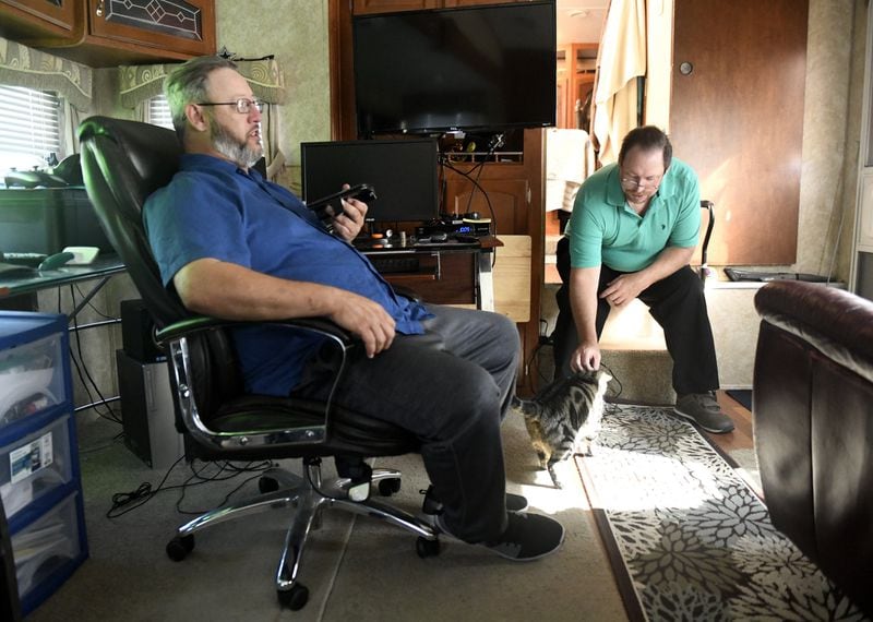 Mark Jones, left, and Kenny Gardiner sit in Jones’ RV on Feb. 28, 2020, in Port Aransas, Texas. The two moved to Port Aransas after their convictions were overturned. ANNIE RICE / FOR THE AJC