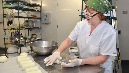 CalyRoad Creamery owner, Robin Schick forms tube shapes of cheese for the final stages before wrapping the product at the facility. (Chris Hunt/Special)