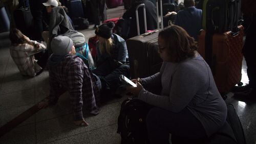 Passengers wait for power to be restored on Sunday, Dec. 17, 2017, at Hartsfield-Jackson International Airport.  The outage began after 1 p.m. and lasted until about midnight.