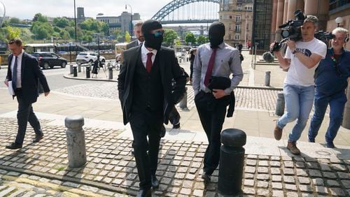Daniel Graham foreground and Adam Carruthers, centre-right, leave Newcastle Upon Tyne Magistrates' Court after appearing in connection with the felling of the Sycamore Gap tree, in Newcastle-upon-Tyne, England, Wednesday, May 15, 2024. The men are charged with causing criminal damage and damaging the wall built in A.D. 122 by Emperor Hadrian to guard the northwest frontier of the Roman Empire. (Owen Humphreys/PA Wire/PA via AP)