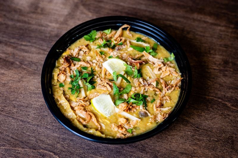 Haleem at Atlanta Halal Meat & Food is an ancient comfort bowl of cracked-wheat (bulgur) porridge, swirled with chopped chicken and topped with matchsticks of fresh ginger, chopped cilantro, fried onions and lime wedges. CONTRIBUTED BY HENRI HOLLIS