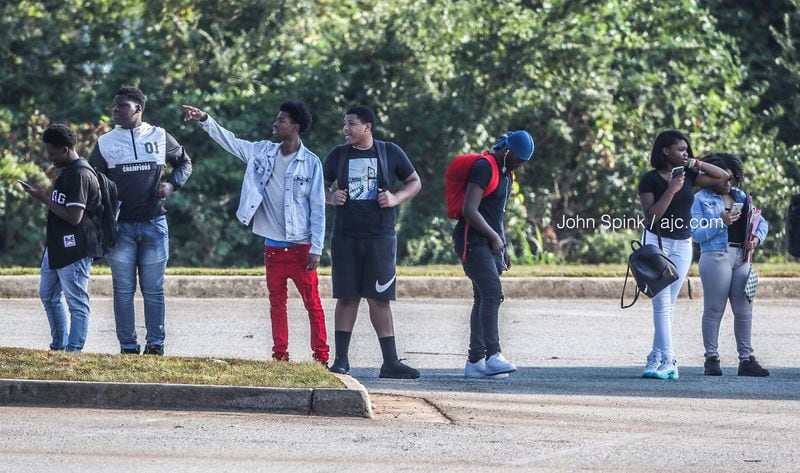 Students stand outside Lithonia High School during a lockdown Tuesday morning.  