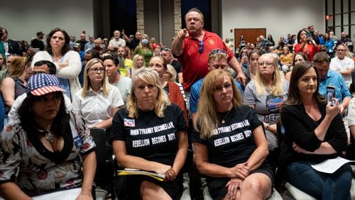 Ron Tripodo (center) yells at the Cherokee County School Board after they passed a resolution to ban teaching critical race theory and then adjourned the meeting Thursday night, May 20, 2021. Tripodo was upset that the language in the resolution was ambiguous and didn’t really do anything. (Ben Gray for The Atlanta Journal-Constitution)