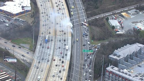 White smoke was seen pouring from beneath I-85 near Piedmont Road on Thursday.