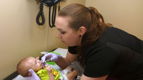 Amanda Smith, a pediatric nurse, examines 3-month-old Liam Falletta Jr. of Blairsville at the Georgia Mountains Health Clinic in Blue Ridge. Georgia Mountains Health provides health care at seven location including two in Blue Ridge, and half of their patients have no insurance whatsoever. In Blue Ridge they have a dental clinic and a wellcare clinic. The clinics are funded in part by a federal program established by President Lyndon B. Johnson as part of the War on Poverty. Congress has not renewed the funding, which expired Sept. 30. (PHOTO by Rebecca Breyer for the AJC)