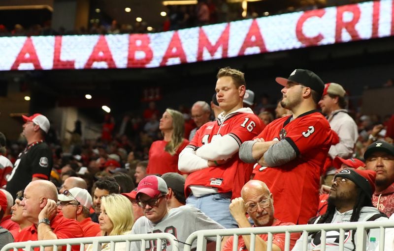 Unhappy Georgia fans after their team falls behind in the third quarter of the SEC Championship football game between the Georgia Bulldogs and the Alabama Crimson Tide.   Curtis Compton / Curtis.Compton@ajc.com 