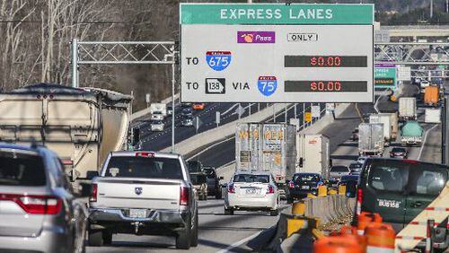 Northbound commuters drive past the lowered gates just south of Hwy 138 along the new I-75 South Metro Express Lanes in Clayton and Henry counties. JOHN SPINK /JSPINK@AJC.COM