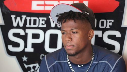 Atlanta Braves outfielder Ronald Acuna takes questions from the media during an interview in the dugout after arriving early for spring training baseball, Thursday, Feb 15, 2018.