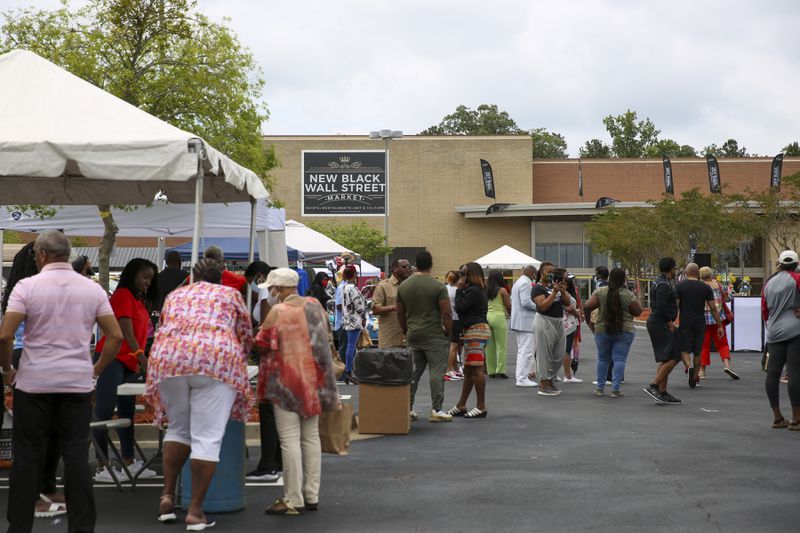 People check out booths at the soft opening of the New Black Wall Street Market in Stonecrest, Georgia, on Saturday, May 29, 2021. (Rebecca Wright for The Atlanta Journal-Constitution)