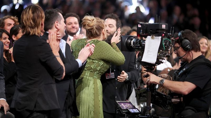 Singer Adele kisses husband Simon Konecki during The 59th GRAMMY Awards at STAPLES Center on February 12, 2017 in Los Angeles.