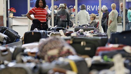 Zanor McWilliams, from Stone Mountain, said she was stuck on the tarmac for eight hours on Sunday during the airport’s power outage, and returned Monday to try to collect her luggage. BOB ANDRES /BANDRES@AJC.COM