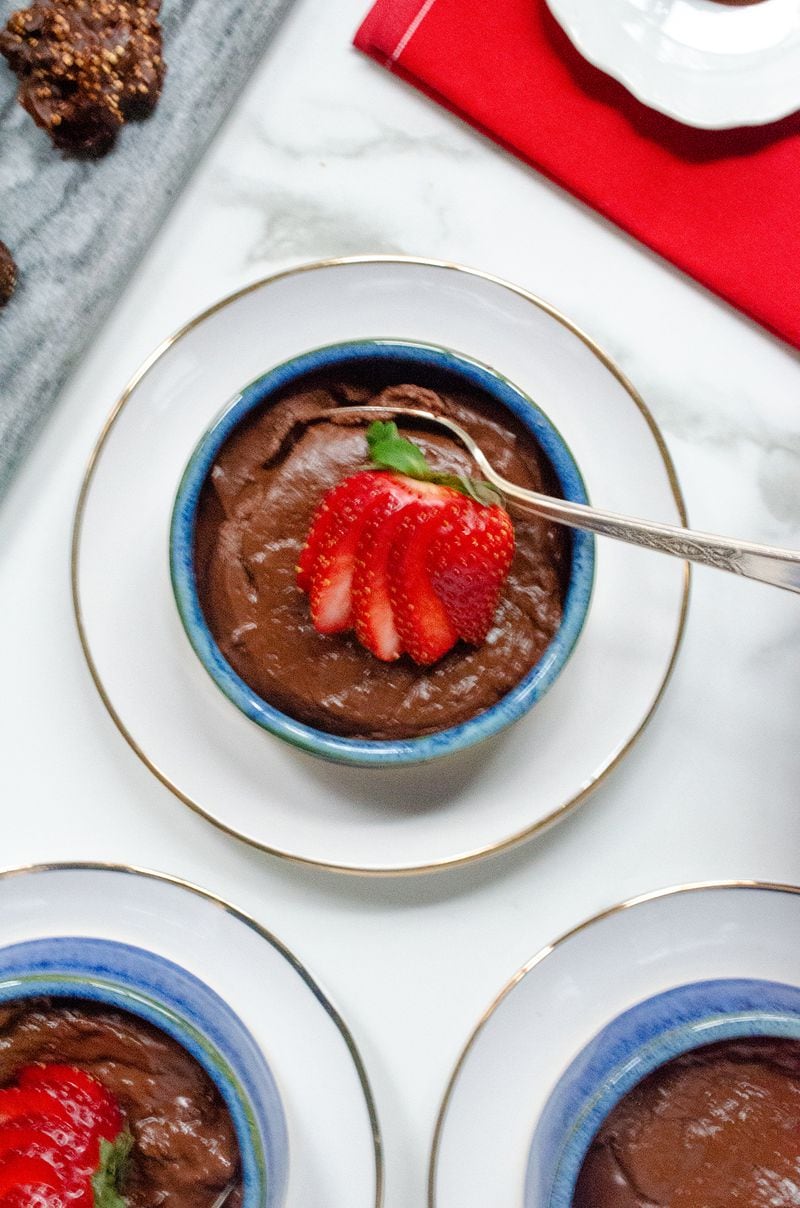 Mocha Bittersweet Chocolate Pudding, garnished here with strawberries, delivers dark chocolate flavor but with less fat and sugar than many recipes. (Virginia Willis for The Atlanta Journal-Constitution)