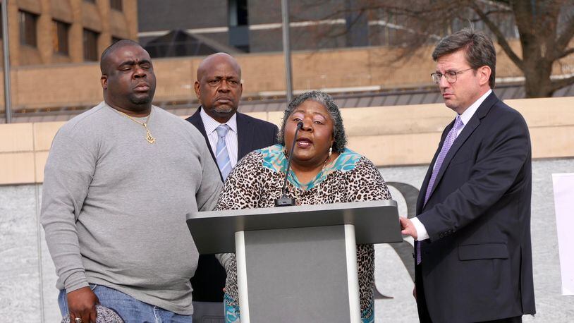 Julian Lewis' widow, Betty Lewis (center), speaks about the death of her late husband. She was flanked Friday by her son Eric Clay (left) and the family's attorneys, Andrew Lampros (right) and Akil Secret. (Courtesy of Diane Crow Photography)