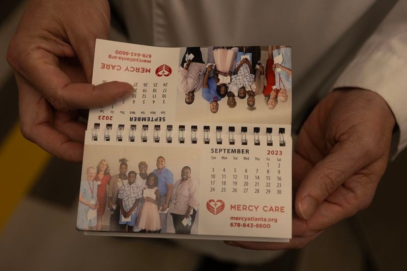 Dr. Reed Pitre shows a tiny calendar on Thursday, June 22, 2023 at Mercy Care in Atlanta. He works with patients in need. His speciality is psychiatry. Dr. Pitre has dedicated his time working with low income patients, including the homeless. (Michael Blackshire/Michael.blackshire@ajc.com)