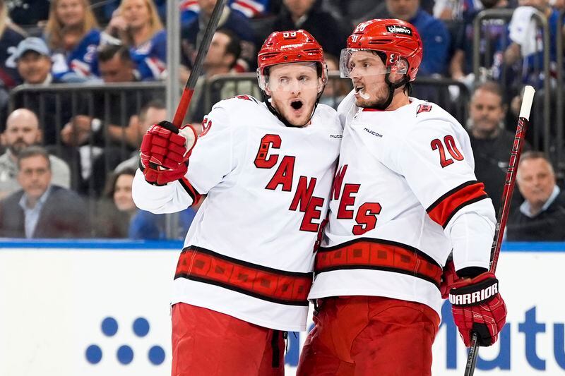 Carolina Hurricanes centers Jake Guentzel (59) and Sebastian Aho (20) celebrate Guentzel's goal during the first period in Game 2 of an NHL hockey Stanley Cup second-round playoff series against the New York Rangers, Tuesday, May 7, 2024, in New York. (AP Photo/Julia Nikhinson)