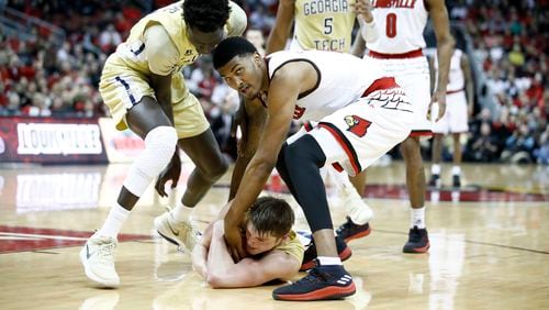 LOUISVILLE, KY - FEBRUARY 08:  Malik Williams #5 of the Louisville Cardinals  battles for a loose ball with Abdoulaye Gueye #34 (left) and Ben Lammers #44 (on floor) of  the Georgia Tech Yellow Jackets during the game at KFC YUM! Center on February 8, 2018 in Louisville, Kentucky.  (Photo by Andy Lyons/Getty Images)