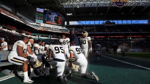 MIAMI GARDENS, FL - OCTOBER 14: The Georgia Tech Yellow Jackets huddle during a game against the Miami Hurricanes at Sun Life Stadium on October 14, 2017 in Miami Gardens, Florida.  (Photo by Mike Ehrmann/Getty Images)