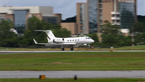 A plane lands at DeKalb-Peachtree Airport on Monday.