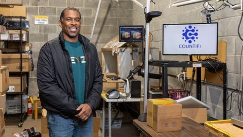 David Hailey, founder of AI warehouse organizing software Countifi, poses for a portrait with a display of his product at ECOMSPACES’ warehouse in Atlanta on Thursday, December 21, 2023. (Arvin Temkar / arvin.temkar@ajc.com)