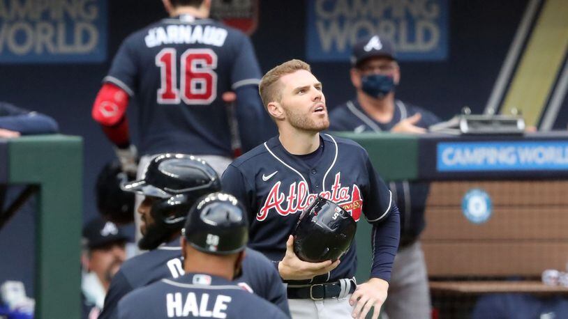 Atlanta Braves first baseman Freddie Freeman, center, reacts as he watches the replay of Los Angeles Dodgers right fielder Mookie Betts (not pictured) making a catch robbing a home run from Atlanta Braves designated hitter Marcell Ozuna (not pictured) during the fifth inning in Game 6 Saturday, Oct. 17, 2020, for the best-of-seven National League Championship Series at Globe Life Field in Arlington, Texas. (Curtis Compton / Curtis.Compton@ajc.com)