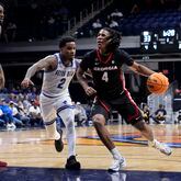 Georgia guard Silas Demary Jr. (4) drives past Seton Hall guard Al-Amir Dawes (2) in the first half of an NCAA college basketball game in the semifinals of the NIT, Tuesday, April 2, 2024, in Indianapolis. (AP Photo/Michael Conroy)