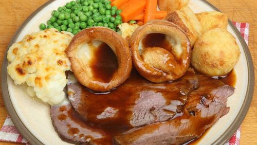 Roast beef with Yorkshire pudding, vegetables and gravy is a standard Sunday dinner in Britain. (GETTY IMAGES)