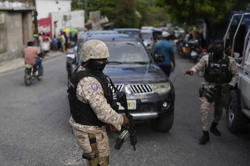 Soldiers deploy outside the Prime Minister's office in Port-au-Prince, Haiti, in preparation for the swearing-in of a transitional council tasked with selecting a new prime minister and cabinet, Thursday, April 25, 2024. (AP Photo/Ramon Espinosa)