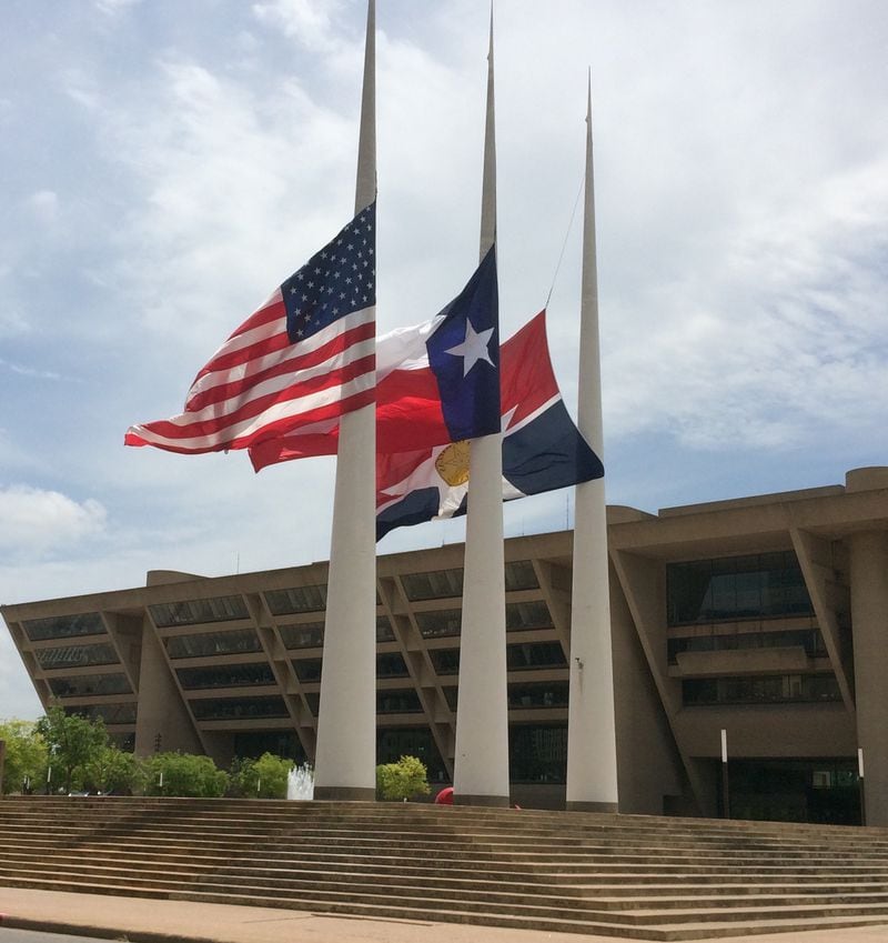 The giant flags outside Dallas City Hall were lowered after a gunman opened fire in July 2016, leaving five law enforcement officers dead. Photo: Jennifer Brett
