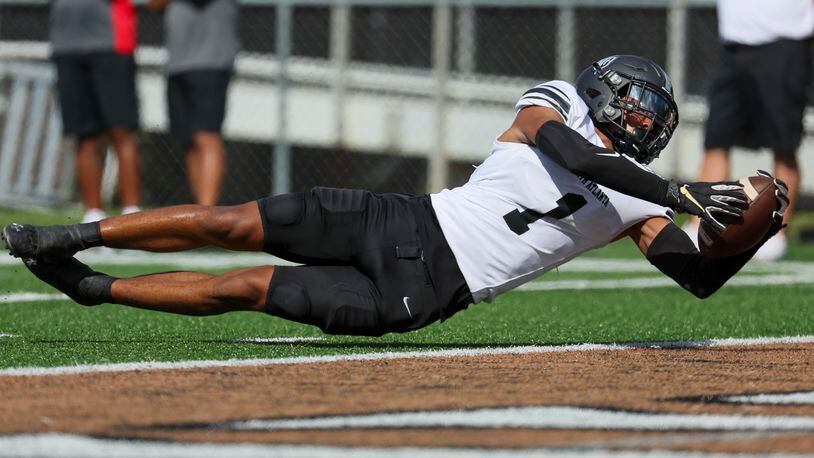 North Atlanta wide receiver Grant Thompson (1) dives for a touchdown after making a long catch during the first half against Johns Creek in the 2023 Corky Kell + Dave Hunter Classic at Kell High School, Wednesday, August 15, 2023, in Marietta, Ga. (Jason Getz / Jason.Getz@ajc.com)